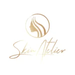 Skin Atelier Clinic logo featuring a golden silhouette of a woman’s profile with flowing hair inside a circle, with elegant script text "Skin Atelier"